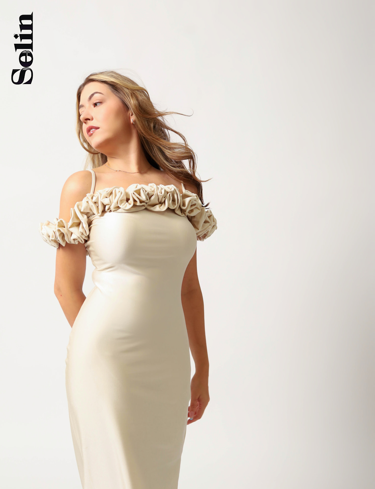 Juste in a cream off-shoulder ruffle dress, hair in motion, Selin magazine